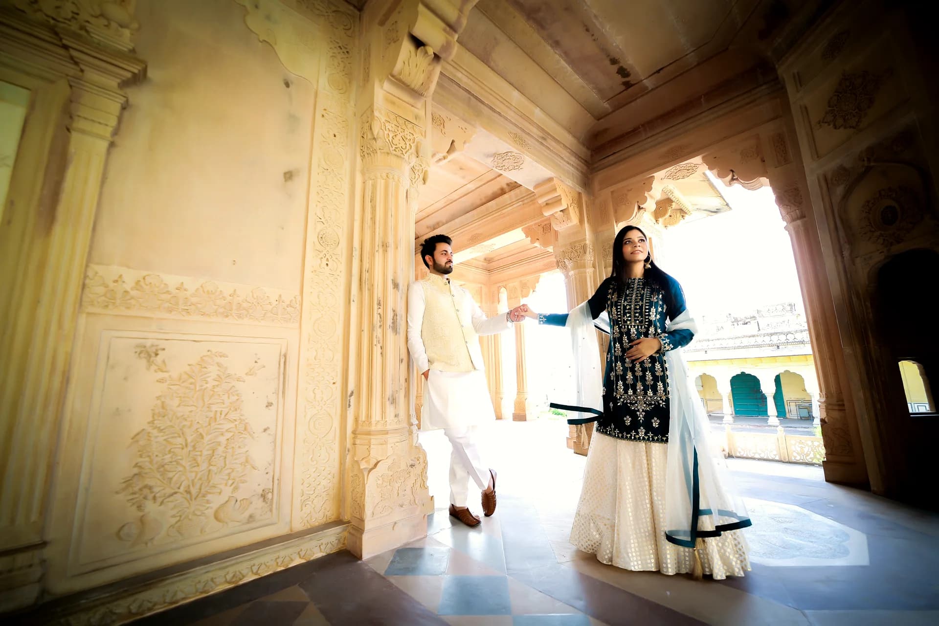 Close-up detail of couple holding hands with engagement ring in soft natural focus (Frame #6)