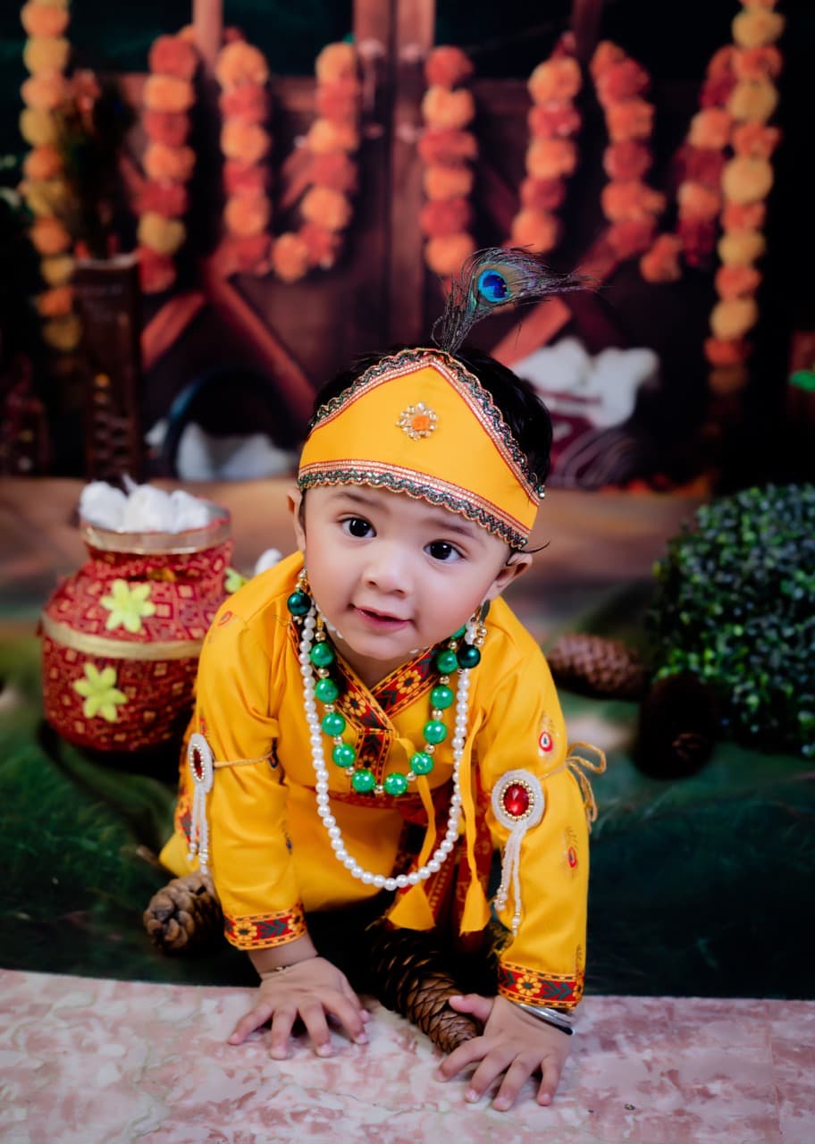 Baby sitting up smiling with cute props