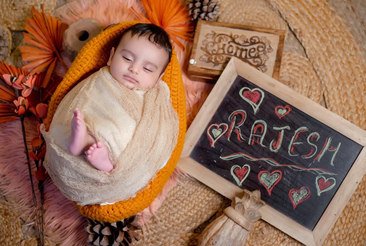 Swaddled newborn sleeping peacefully on textured backdrop